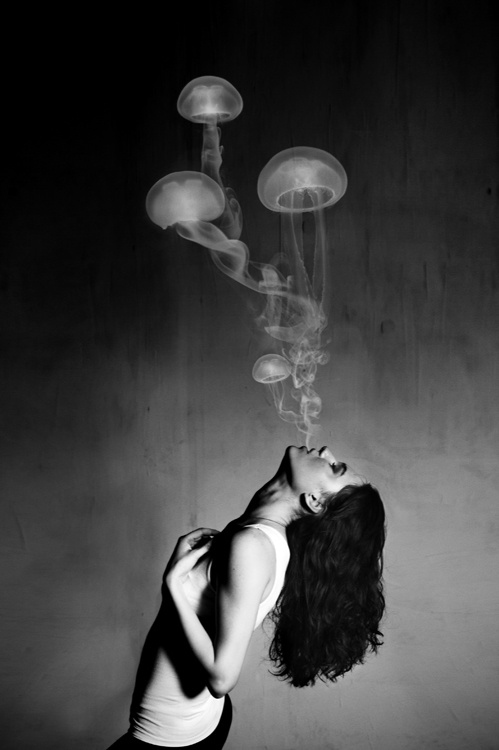 woman blowing jellyfish vapors